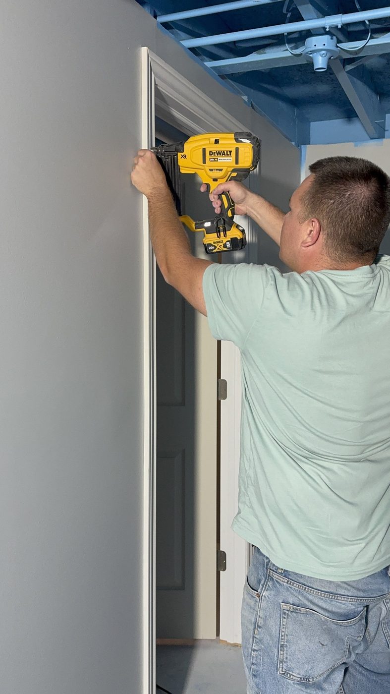 Carpenter cutting trim with a mitre saw